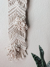 Load image into Gallery viewer, Bottom of a natural white vertical macrame wall hanging with cotton cord hand knotted on driftwood
