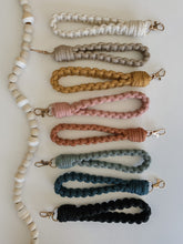 Load image into Gallery viewer, Natural White, oatmeal, mustard yellow, blush pink, terra cotta, laurel, peacock blue, and black macrame wristlet keychain
