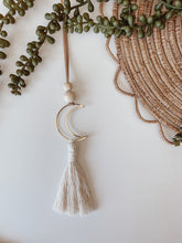 Load image into Gallery viewer, A single gold crescent moon charm with cotton tassels 
