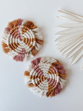 Load image into Gallery viewer, Two white, pink, and yellow macrame coasters

