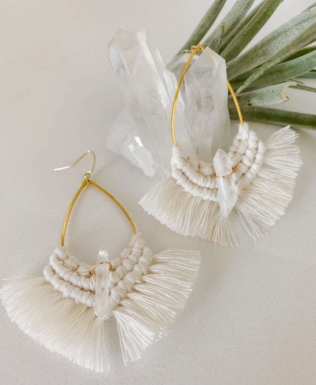 A pair of natural white macrame drop oval earrings with crystal quartz gem 