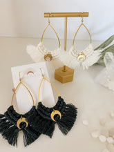 Load image into Gallery viewer, A pair of brass drop earrings with navy cotton fringe and gold crescent moon charms 
