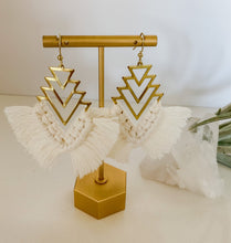 Load image into Gallery viewer, A pair of fringe drop earrings with brass geometric findings and cotton cord fringe seen on a jewelry stand
