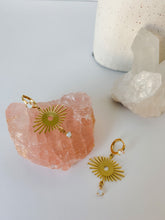 Load image into Gallery viewer, A pair of gold plated huggies with gold sun charm and opal gemstones 
