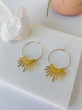 Load image into Gallery viewer, A pair of gold plated 30mm hoop earrings with a rising moon charm 
