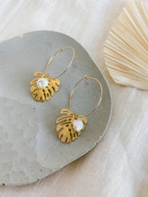 Load image into Gallery viewer, A pair of gold plated 30mm hoop earrings with gold plated monstera charm and freshwater pearl 
