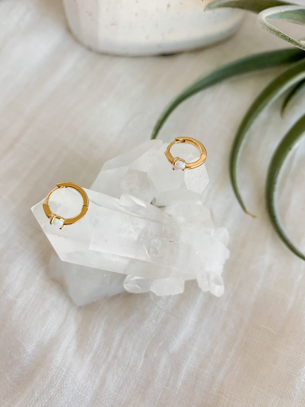 Gold huggie hoop earrings with opal gemstone